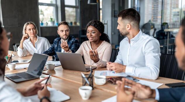 african businesswoman on business meeting with coworkers talking discussing project brainstorming ideas sitting together in modern office corporate teamwork concept photo